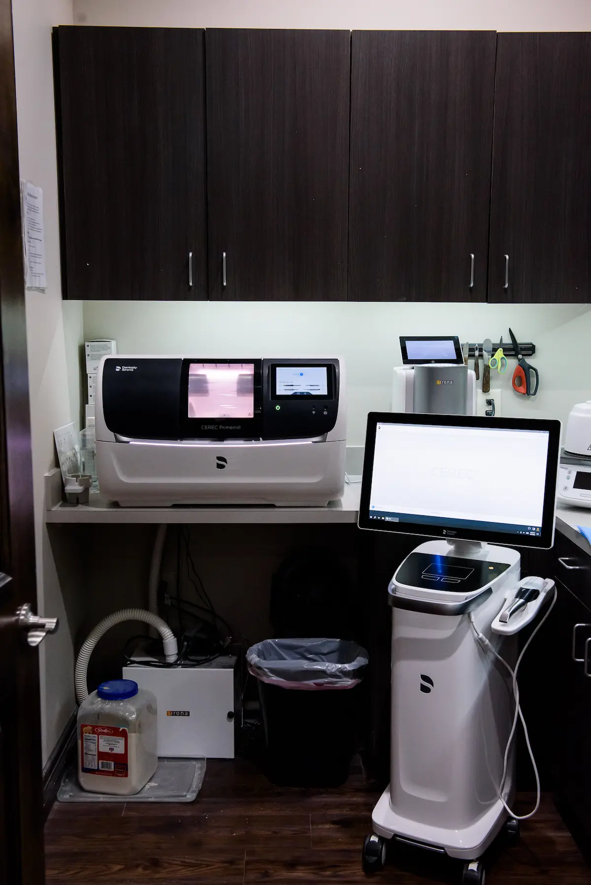 Digital dental lab featuring CEREC Primemill and design workstation—highlighting precision technology for same-day crowns and restorations.